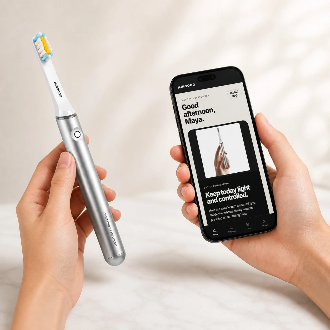 Miroooo X2 toothbrush held beside the Smile Coach app
